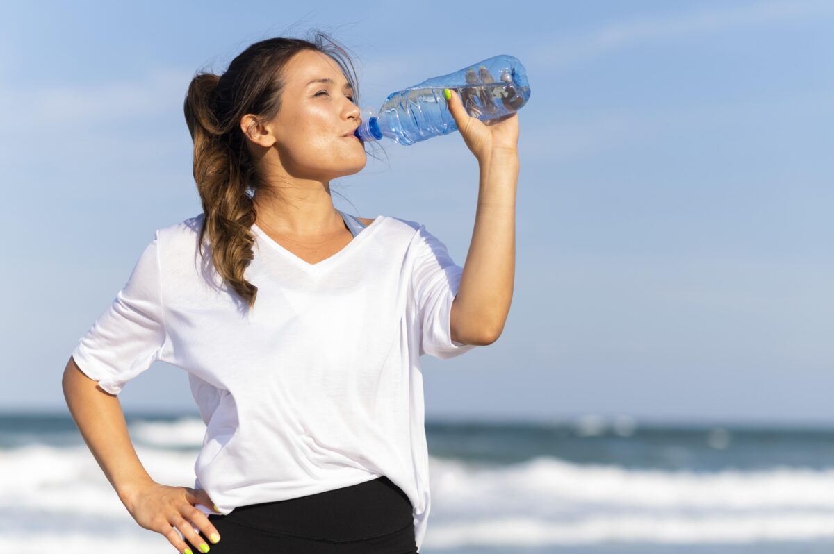 woman-staying-hydrated-beach-while-working-out-1-1200x798.jpg